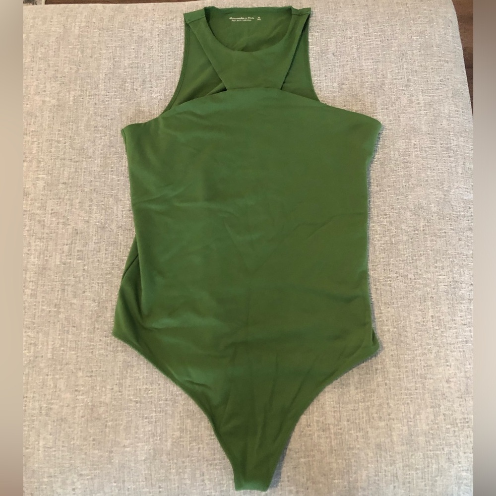 Halter-neck bodysuit originally from Abercrombie and Fitch. Has snaps.